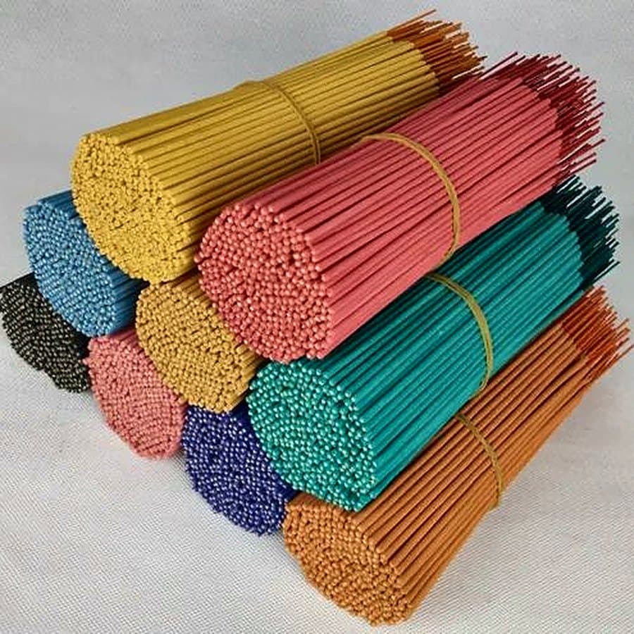 Bundles of coloured agarbatti in yellow, pink, green, blue and orange