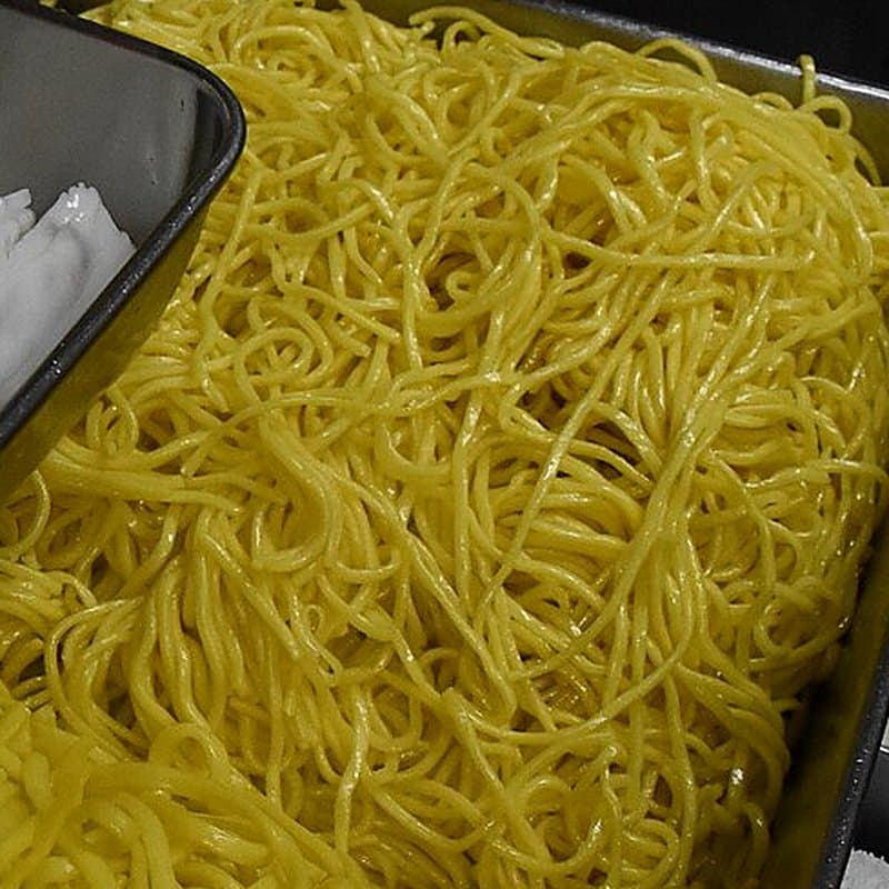 Tray of fresh yellow noodles after steaming