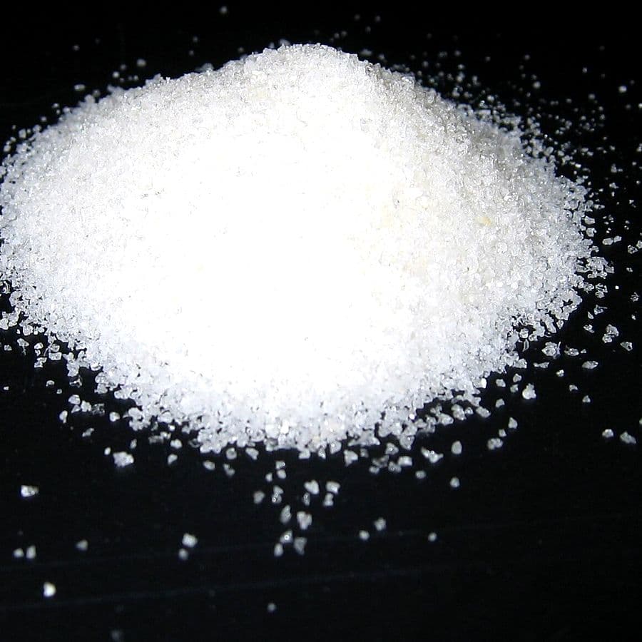 White super absorbent polymer granules, the material that holds liquid inside a sanitary pad core