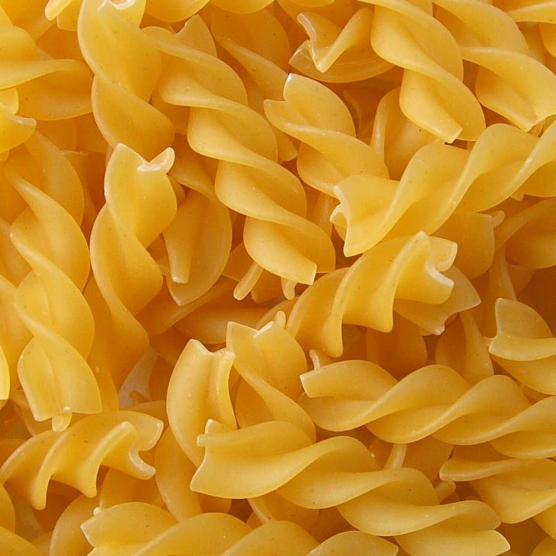 Dry yellow fusilli spirals filling the frame