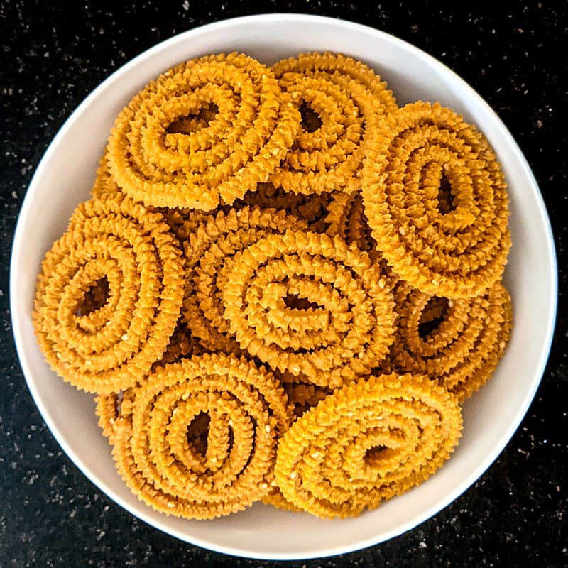 A bowl of spiral chakli, one of the snacks a sevai machine makes with a different die