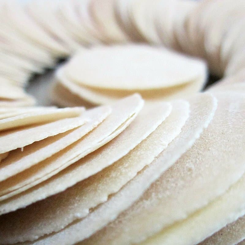 Stack of raw round papad discs before drying