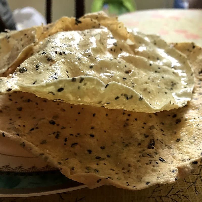 Roasted masala papad with black pepper specks