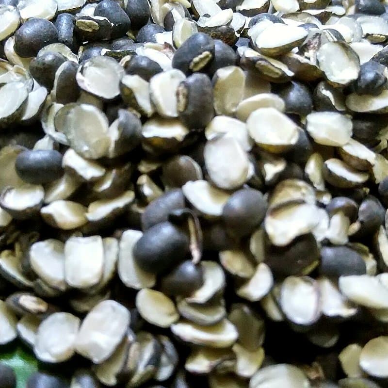 Split black gram urad dal with skin on a banana leaf