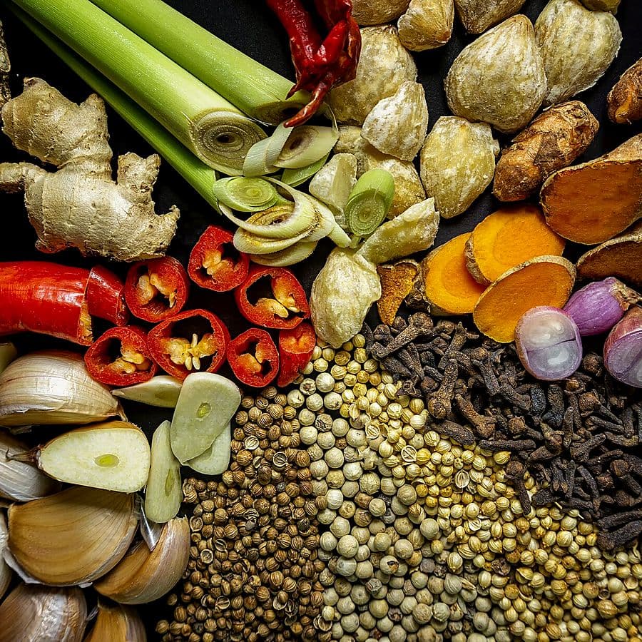 Assorted whole spices including chillies and cardamom